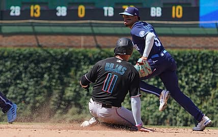 Aug 5, 2022; Chicago, Illinois, USA; Miami Marlins shortstop Miguel Rojas (11) steals second base as Chicago Cubs shortstop Christopher Morel (5) covers the base during the fifth inning at Wrigley Field. Mandatory Credit: David Banks-USA TODAY Sports