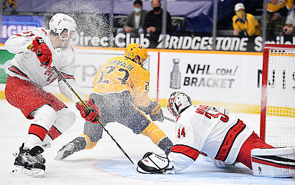 May 10, 2021; Nashville, Tennessee, USA; Nashville Predators right wing Rocco Grimaldi (23) scores a short handed goal past Carolina Hurricanes goaltender Petr Mrazek (34) during the first period at Bridgestone Arena. Mandatory Credit: Christopher Hanewinckel-USA TODAY Sports
