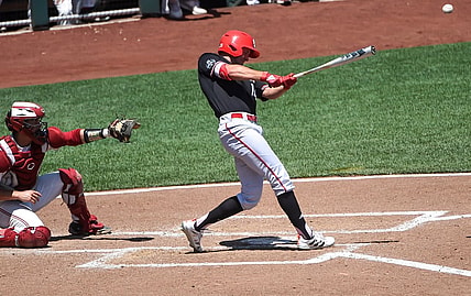 Jun 19, 2021; Omaha, Nebraska, USA;  NC State Wolfpack outfielder Jonny Butler (14) singles in two runs in the fourth inning against the Stanford Cardinal at TD Ameritrade Park. Mandatory Credit: Steven Branscombe-USA TODAY Sports