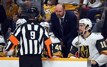 Nov 24, 2021; Nashville, Tennessee, USA; Vegas Golden Knights head coach Peter DeBoer challenges a goal call by referee Dan O'Rourke (9) during the second period against the Nashville Predators at Bridgestone Arena. Mandatory Credit: Christopher Hanewinckel-USA TODAY Sports