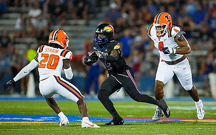 Sep 8, 2023; Lawrence, Kansas, USA; Kansas Jayhawks running back Devin Neal (4) runs the ball against Illinois Fighting Illini defensive back Tyler Strain (20) and defensive lineman Jer'Zhan Newton (4) during the second half at David Booth Kansas Memorial Stadium. Mandatory Credit: Jay Biggerstaff-USA TODAY Sports