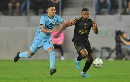 May 1, 2022; Los Angeles, California, USA; Minnesota United midfielder Emanuel Reynoso (10) chases Los Angeles FC defender Diego Palacios (12) during the first half at Banc of California Stadium. Mandatory Credit: Jayne Kamin-Oncea-USA TODAY Sports