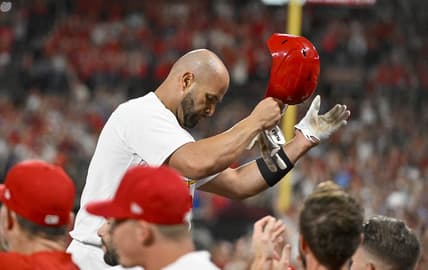 Sep 16, 2022; St. Louis, Missouri, USA;  St. Louis Cardinals designated hitter Albert Pujols (5) salutes the fans as he receives a standing ovation after hitting a game tying two run home run for his 698th career home run during the sixth inning against the Cincinnati Reds at Busch Stadium. Mandatory Credit: Jeff Curry-USA TODAY Sports