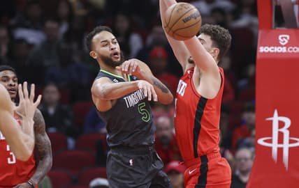 Jan 8, 2023; Houston, Texas, USA; Minnesota Timberwolves forward Kyle Anderson (5) passes the ball around Houston Rockets center Alperen Sengun (28) during the first quarter at Toyota Center. Mandatory Credit: Troy Taormina-USA TODAY Sports