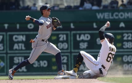Apr 12, 2023; Pittsburgh, Pennsylvania, USA;  Houston Astros second baseman Mauricio Dubon (14) turns a double play over Pittsburgh Pirates center fielder Jack Suwinski (65) during the fifth inning at PNC Park. Mandatory Credit: Charles LeClaire-USA TODAY Sports