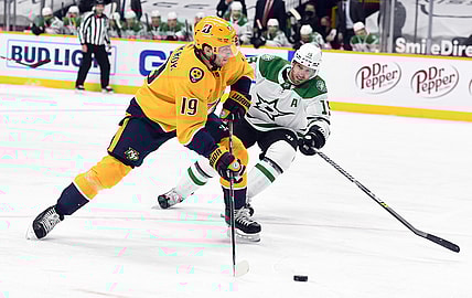 Apr 1, 2021; Nashville, Tennessee, USA; Nashville Predators center Calle Jarnkrok (19) shoots ahead of pressure from Dallas Stars left wing Blake Comeau (15) during the first period at Bridgestone Arena. Mandatory Credit: Christopher Hanewinckel-USA TODAY Sports
