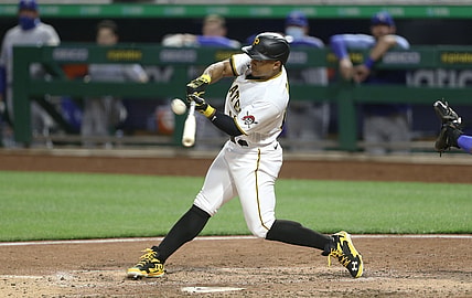 Apr 27, 2021; Pittsburgh, Pennsylvania, USA; Pittsburgh Pirates pinch hitter Wilmer Difo (15) hits an RBI single against the Kansas City Royals during the seventh inning at PNC Park. Mandatory Credit: Charles LeClaire-USA TODAY Sports