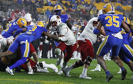 Oct 14, 2023; Pittsburgh, Pennsylvania, USA; Louisville Cardinals running back Isaac Guerendo (middle) scores a touchdown against the Pittsburgh Panthers during the second quarter at Acrisure Stadium. Mandatory Credit: Charles LeClaire-USA TODAY Sports
