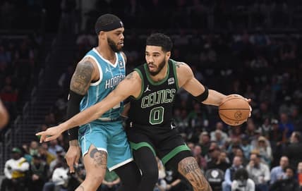 Nov 20, 2023; Charlotte, North Carolina, USA; Boston Celtics forward Jayson Tatum (0) looks to drive past Charlotte Hornets forward Miles Bridges (0) during the first half at the Spectrum Center. Mandatory Credit: Sam Sharpe-USA TODAY Sports