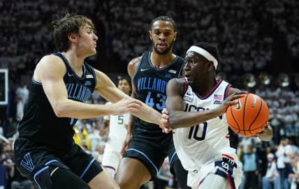 Feb 24, 2024; Storrs, Connecticut, USA; UConn Huskies guard Hassan Diarra (10) drives the ball against Villanova Wildcats forward Eric Dixon (43) and guard Brendan Hausen (1) in the second half at Harry A. Gampel Pavilion. Mandatory Credit: David Butler II-USA TODAY Sports