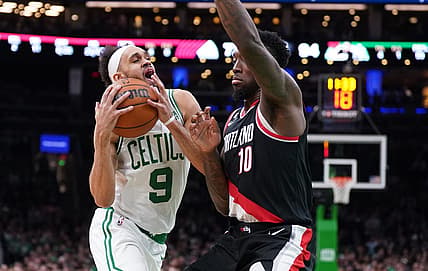 Mar 8, 2023; Boston, Massachusetts, USA; Boston Celtics guard Derrick White (9) drives the ball against Portland Trail Blazers forward Nassir Little (10) in the second half at TD Garden. Mandatory Credit: David Butler II-USA TODAY Sports