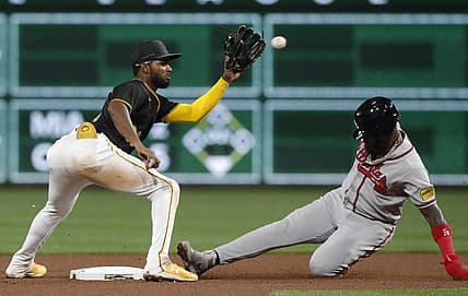 Aug 7, 2023; Pittsburgh, Pennsylvania, USA; Atlanta Braves designated hitter Marcell Ozuna (right) steals second base as Pittsburgh Pirates second baseman Liover Peguero (left) takes the throw during the sixth inning at PNC Park. Mandatory Credit: Charles LeClaire-USA TODAY Sports