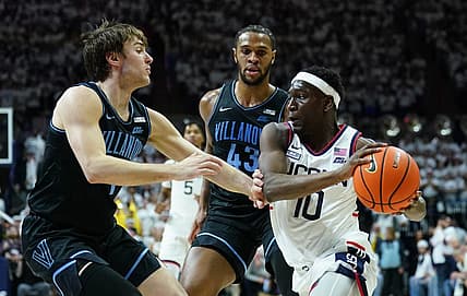 Feb 24, 2024; Storrs, Connecticut, USA; UConn Huskies guard Hassan Diarra (10) drives the ball against Villanova Wildcats forward Eric Dixon (43) and guard Brendan Hausen (1) in the second half at Harry A. Gampel Pavilion. Mandatory Credit: David Butler II-USA TODAY Sports
