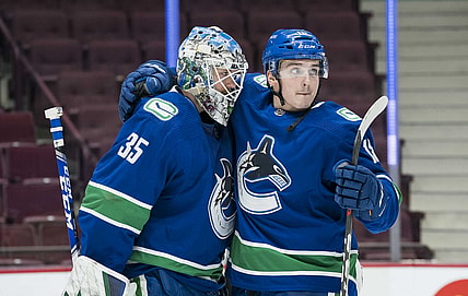 Mar 4, 2021; Vancouver, British Columbia, CAN; Vancouver Canucks goalie Thatcher Demko (35) and forward Jake Virtanen (18) celebrate their victory against the Toronto Maple Leafs in the third period at Rogers Arena. Canucks won 3-1. Mandatory Credit: Bob Frid-USA TODAY Sports
