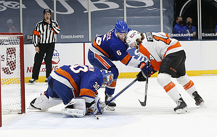 Apr 3, 2021; Uniondale, New York, USA; New York Islanders goaltender Ilya Sorokin (30) covers the puck as defenseman Ryan Pulock (6) checks Philadelphia Flyers center Sean Couturier (14) during the first period at Nassau Veterans Memorial Coliseum. Mandatory Credit: Andy Marlin-USA TODAY Sports
