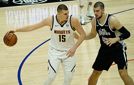 May 1, 2021; Los Angeles, California, USA; Denver Nuggets center Nikola Jokic (15) moves the ball against Los Angeles Clippers center Ivica Zubac (40) during the first half at Staples Center. Mandatory Credit: Gary A. Vasquez-USA TODAY Sports