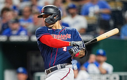 Sep 20, 2022; Kansas City, Missouri, USA; Minnesota Twins shortstop Carlos Correa (4) hits a two-run single against the Kansas City Royals during the second inning at Kauffman Stadium. Mandatory Credit: Jay Biggerstaff-USA TODAY Sports