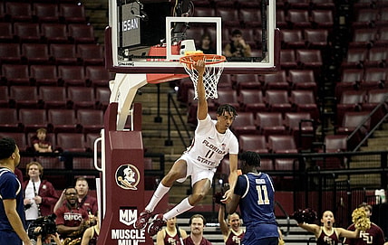 Jan 3, 2024; Tallahassee, Florida, USA; Florida State Seminoles forward Baba Miller (11) hangs on the rim after a dunk during the first half against the Georgia Tech Yellow Jackets at Donald L. Tucker Center. Mandatory Credit: Melina Myers-USA TODAY Sports