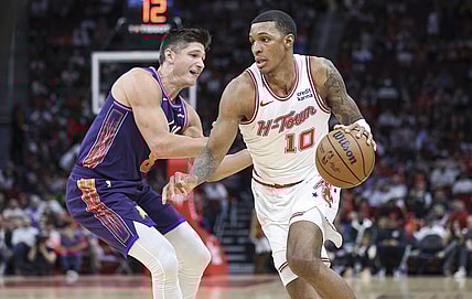 Feb 23, 2024; Houston, Texas, USA; Houston Rockets forward Jabari Smith Jr. (10) dribbles the ball as Phoenix Suns guard Grayson Allen (8) defends during the second quarter at Toyota Center. Mandatory Credit: Troy Taormina-USA TODAY Sports