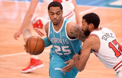 May 6, 2021; Charlotte, North Carolina, USA;  Charlotte Hornets forward center PJ Washington (25) drives past Chicago Bulls guard forward Garrett Temple (17) during the first half at the Spectrum Center. Mandatory Credit: Sam Sharpe-USA TODAY Sports.