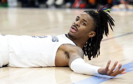 Mar 11, 2022; Memphis, Tennessee, USA; Memphis Grizzlies guard Ja Morant (12) lays on the floor after a foul during the second half against the New York Knicks at FedExForum. Mandatory Credit: Petre Thomas-USA TODAY Sports