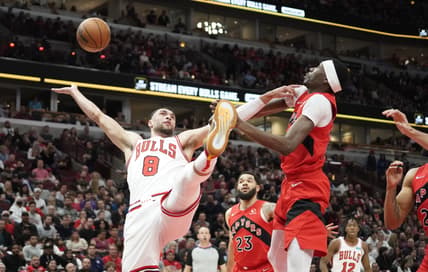 Mar 21, 2022; Chicago, Illinois, USA; Toronto Raptors forward Chris Boucher (25) defends Chicago Bulls guard Zach LaVine (8) during the first quarter at United Center. Mandatory Credit: David Banks-USA TODAY Sports