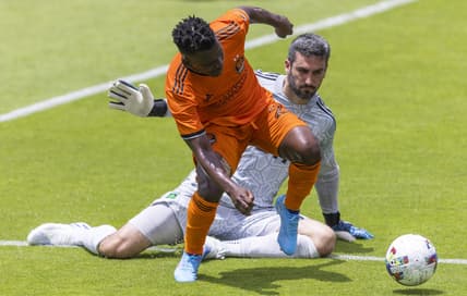 Apr 30, 2022; Houston, Texas, USA; Houston Dynamo FC forward Darwin Quintero (23) dribbles against Austin FC goalkeeper Andrew Tarbell (31) in the first half at PNC Stadium. Mandatory Credit: Thomas Shea-USA TODAY Sports