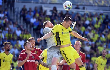 May 8, 2022; Nashville, Tennessee, USA; Nashville SC midfielder Alex Muyl (19) collides with Real Salt Lake goalkeeper Zac MacMath (18) on a corner kick during the first half at Geodis Park. Mandatory Credit: Christopher Hanewinckel-USA TODAY Sports