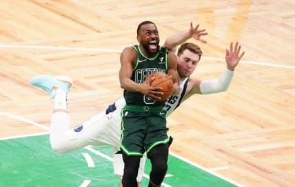Mar 31, 2021; Boston, Massachusetts, USA; Boston Celtics guard Kemba Walker (8) is fouled by Dallas Mavericks guard Luka Doncic (77) during the fourth quarter at TD Garden. Mandatory Credit: David Butler II-USA TODAY Sports