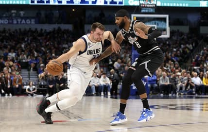 Nov 15, 2022; Dallas, Texas, USA;  Dallas Mavericks guard Luka Doncic (77) dribbles as LA Clippers forward Marcus Morris Sr. (8) defends during the first quarter at American Airlines Center. Mandatory Credit: Kevin Jairaj-USA TODAY Sports