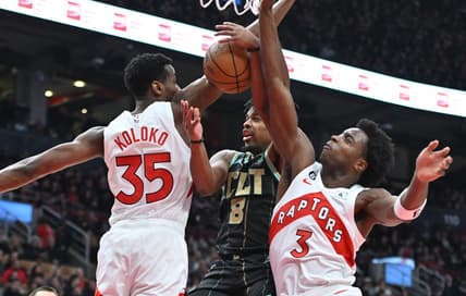Jan 10, 2023; Toronto, Ontario, CAN;  Charlotte Hornets guard Dennis Smith Jr. (8) has his shot attempt blocked by Toronto Raptors center Christian Koloko (35) and forward OG Anunoby (3) in the first half at Scotiabank Arena. Mandatory Credit: Dan Hamilton-USA TODAY Sports