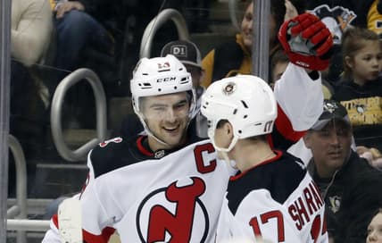Feb 18, 2023; Pittsburgh, Pennsylvania, USA;  New Jersey Devils center Nico Hischier (13) celebrates with center Yegor Sharangovich (17) after Hischier scored a goal against the Pittsburgh Penguins during the second period at PPG Paints Arena. Mandatory Credit: Charles LeClaire-USA TODAY Sports