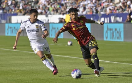 Apr 1, 2023; Carson, California, USA; Seattle Sounders midfielder Leo Chu (23) drives the ball past Los Angeles Galaxy midfielder Memo Rodriguez (20) in the first half against the Los Angeles Galaxy at Dignity Health Sports Park. Mandatory Credit: Jayne Kamin-Oncea-USA TODAY Sports