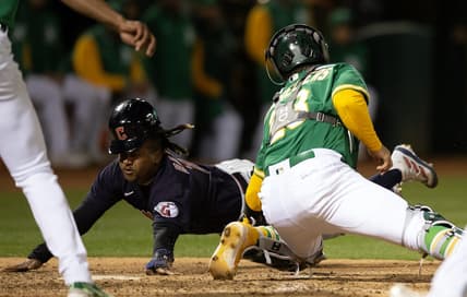 Apr 3, 2023; Oakland, California, USA; Cleveland Guardians third baseman Jose Ramirez (11) eludes the tag by Oakland Athletics catcher Shea Langeliers (23) as he scores on a sacrifice fly by Josh Bell during the eighth inning at RingCentral Coliseum. Mandatory Credit: D. Ross Cameron-USA TODAY Sports