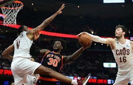 Apr 18, 2023; Cleveland, Ohio, USA; New York Knicks forward Julius Randle (30) drives to the basket between Cleveland Cavaliers forward Evan Mobley (4) and forward Cedi Osman (16) during the second quarter of game two of the 2023 NBA playoffs at Rocket Mortgage FieldHouse. Mandatory Credit: Ken Blaze-USA TODAY Sports