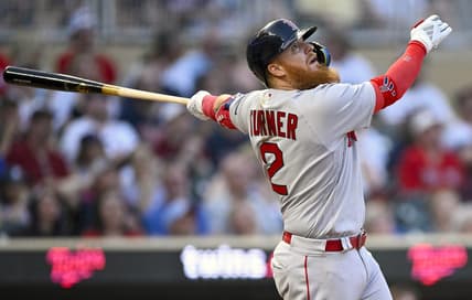 Jun 20, 2023; Minneapolis, Minnesota, USA;  Boston Red Sox designated hitter Justin Turner (2) hits an RBI double against the Minnesota Twins during the seventh inning at Target Field. Mandatory Credit: Nick Wosika-USA TODAY Sports