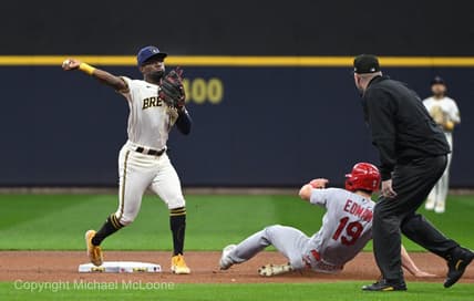 Sep 27, 2023; Milwaukee, Wisconsin, USA; Milwaukee Brewers second baseman Andruw Monasterio (14) forces out St. Louis Cardinals shortstop Tommy Edman (19) and turns the double play in the first inning at American Family Field. Mandatory Credit: Michael McLoone-USA TODAY Sports
