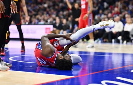 Dec 8, 2023; Philadelphia, Pennsylvania, USA; Philadelphia 76ers center Joel Embiid (21) grabs his knee after falling against the Atlanta Hawks in the fourth quarter at Wells Fargo Center. Mandatory Credit: Kyle Ross-USA TODAY Sports