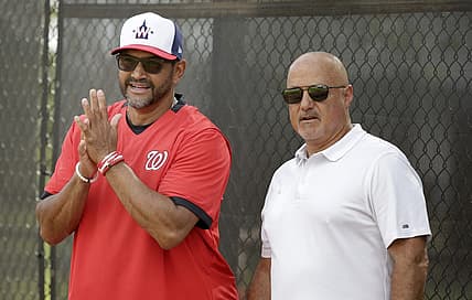 Feb 13, 2020; West Palm Beach, Florida, USA; Washington Nationals manager Dave Martinez (4) and general manager Mike Rizzo watch the pitchers warm up during a  spring training workout at FITTEAM Ballpark. Mandatory Credit: Rhona Wise-USA TODAY Sports