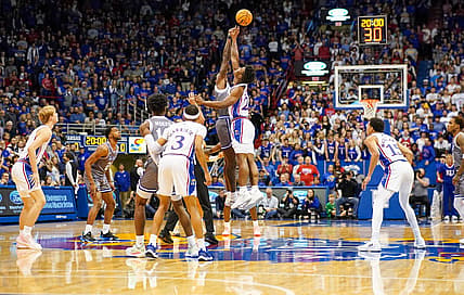 Dec 1, 2022; Lawrence, Kansas, USA; Seton Hall Pirates forward Tyrese Samuel (4) and Kansas Jayhawks forward K.J. Adams Jr. (24) battle for the opening jump ball during the first half at Allen Fieldhouse. Mandatory Credit: Denny Medley-USA TODAY Sports