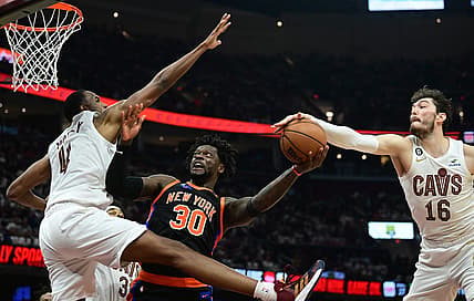 Apr 18, 2023; Cleveland, Ohio, USA; New York Knicks forward Julius Randle (30) drives to the basket between Cleveland Cavaliers forward Evan Mobley (4) and forward Cedi Osman (16) during the second quarter of game two of the 2023 NBA playoffs at Rocket Mortgage FieldHouse. Mandatory Credit: Ken Blaze-USA TODAY Sports