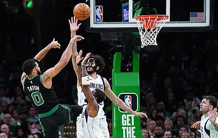 Mar 1, 2024; Boston, Massachusetts, USA; Dallas Mavericks center Dereck Lively II (2) and guard Kyrie Irving (11) defend against Boston Celtics forward Jayson Tatum (0) in the second quarter at TD Garden. Mandatory Credit: David Butler II-USA TODAY Sports