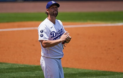 May 30, 2021; Los Angeles, California, USA; Los Angeles Dodgers starting pitcher Clayton Kershaw (22) rubs up a new baseball after giving up a two-run home run to San Francisco Giants shortstop Mauricio Dubon (not pictured) during the first inning at Dodger Stadium. Mandatory Credit: Robert Hanashiro-USA TODAY Sports