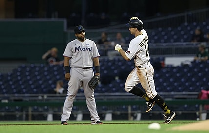 Jun 3, 2021; Pittsburgh, Pennsylvania, USA;  Miami Marlins first baseman Jesus Aguilar (left) reacts as Pittsburgh Pirates center fielder Bryan Reynolds (10) circles the bases on a solo home run during the fourth inning at PNC Park. Mandatory Credit: Charles LeClaire-USA TODAY Sports
