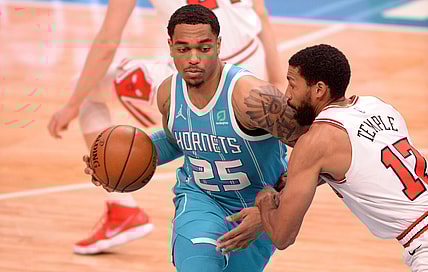 May 6, 2021; Charlotte, North Carolina, USA;  Charlotte Hornets forward center PJ Washington (25) drives past Chicago Bulls guard forward Garrett Temple (17) during the first half at the Spectrum Center. Mandatory Credit: Sam Sharpe-USA TODAY Sports.