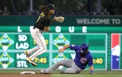 Sep 28, 2021; Pittsburgh, Pennsylvania, USA;  Pittsburgh Pirates second baseman Cole Tucker (3) avoids the slide of Chicago Cubs right fielder Nick Martini (62) after throwing to first base to complete a double pay during the second inning at PNC Park. Mandatory Credit: Charles LeClaire-USA TODAY Sports