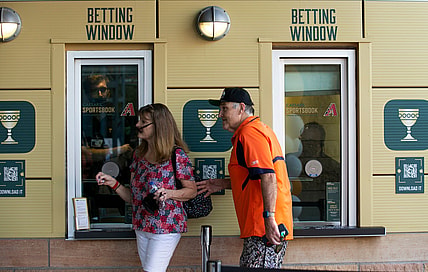 Marlys Kybartas and her husband, Ed Kybartas, walk by the Caesars Sportsbook betting window at Chase Field in Phoenix on the first day of sports betting on Sept. 9, 2021.

Caesars Sportsbook At Chase Field