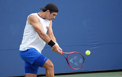 Aug 30, 2022; Flushing, NY, USA; Marcos Giron of the United States hits a shot against Frances Tiafoe of the United States on day two of the 2022 U.S. Open tennis tournament at USTA Billie Jean King National Tennis Center. Mandatory Credit: Jerry Lai-USA TODAY Sports