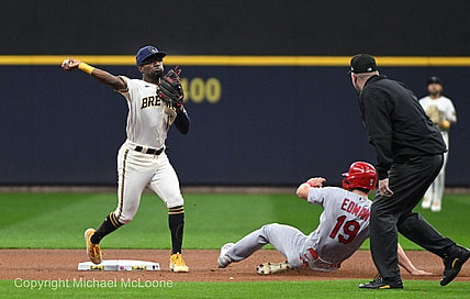 Sep 27, 2023; Milwaukee, Wisconsin, USA; Milwaukee Brewers second baseman Andruw Monasterio (14) forces out St. Louis Cardinals shortstop Tommy Edman (19) and turns the double play in the first inning at American Family Field. Mandatory Credit: Michael McLoone-USA TODAY Sports
