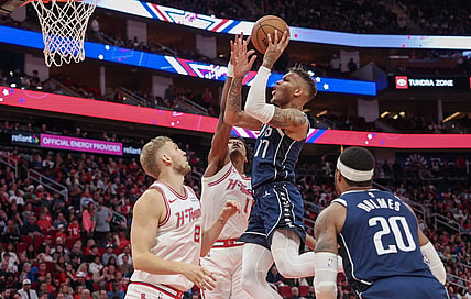 Dec 22, 2023; Houston, Texas, USA; Dallas Mavericks guard Dexter Dennis (17) shoots against Houston Rockets forward Amen Thompson (1) in the second half at Toyota Center. Mandatory Credit: Thomas Shea-USA TODAY Sports